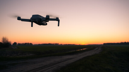 Fototapeta na wymiar drone at sunset, quadrocopter against the sky