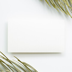 Blank memo pad with tropical dry leaf on white background. top view, copy space