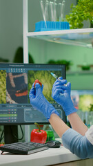 Scientist injecting strawberry with pesticides discovery genetic mutation of fruits for organic...