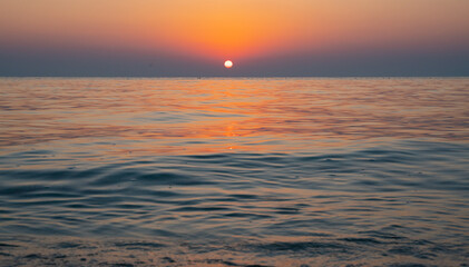 Fototapeta na wymiar Colorful vibrant ocean beach sunrise during a summer day. beautiful sunrise