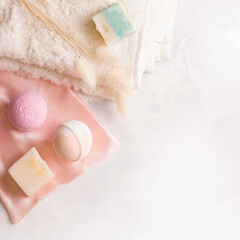 Bath bombs on a towel next to soap. White background. Copy space