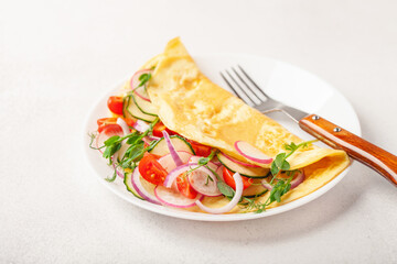 Stuffed vegetable omelette - cucumber, tomato, radish, onions and pea sprouts. Healthy breakfast.