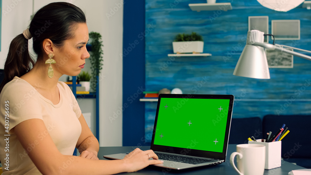 Poster business woman working at online coomunication project using laptop computer with mock up green scre