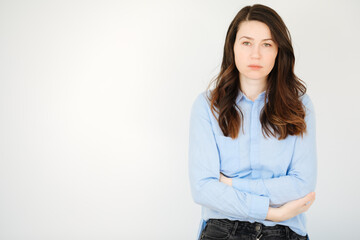 Portrait of a sad and tired woman. Dissatisfaction and anger. Feeling upset. Copy space