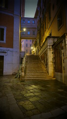 Fototapeta na wymiar Old European illuminated street at rainy night