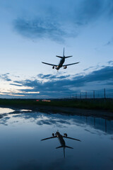 landing plane with reflection in the water