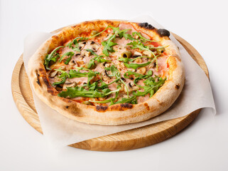 Top view of hot pizza on a wooden stand.
