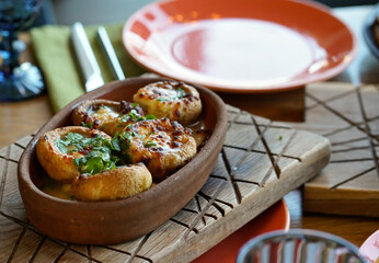 hot snacks. serve stuffed mushrooms in a pot. Oriental cuisine. 