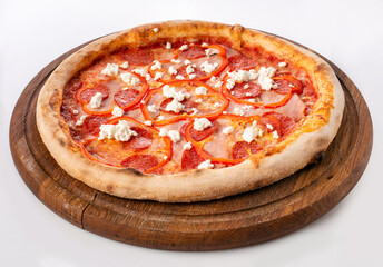 Top view of hot pizza on a wooden stand.