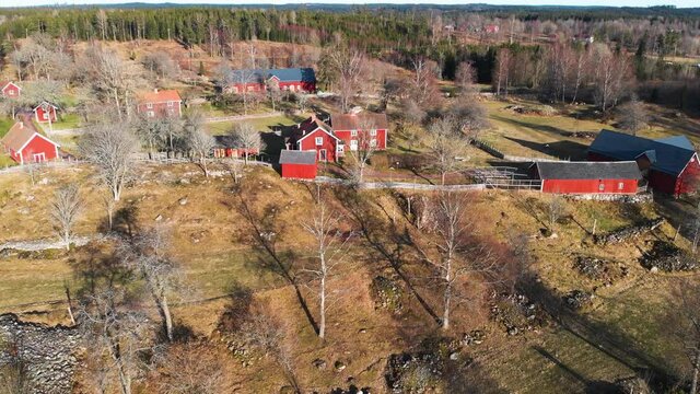 Aerial small village Åsens By Swedish farmland culture reserve red houses day