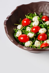 Caprese salad. Fresh arugula, cherry tomatoes, juicy mini mozzarella and a dressing of oregano and olive oil