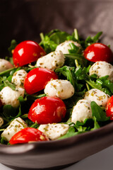 Caprese salad. Fresh arugula, cherry tomatoes, juicy mini mozzarella and a dressing of oregano and olive oil