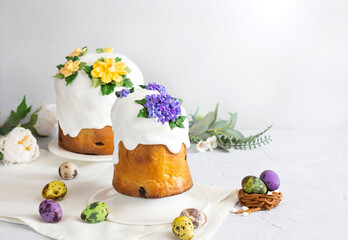 Easter cakes and colorful eggs composition on the white background with copy space.