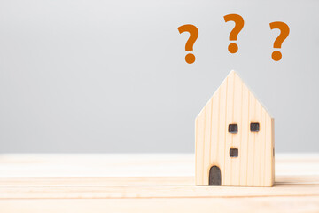 wooden house model on table background. Home, Crisis, Economic recession, Homeless, Real Estate, Buy or Rent and Property concept