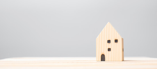 wooden house model on table background. Home, Crisis, Economic recession, Homeless, Real Estate, Buy or Rent and Property concept