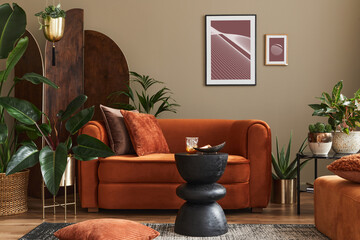 Domestic interior of living room with design sofa, mock up poster frames, a lot of plants, coffee...