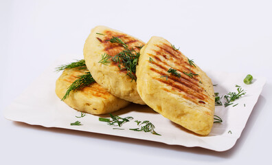 Fried potato pies. Patties with dill. Cheap recipe for homemade fried pies on a white background....
