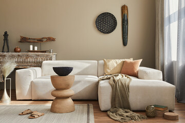 Stylish ethnic living room interior with design modular sofa, wooden stool, moroccan shelf, carpet...