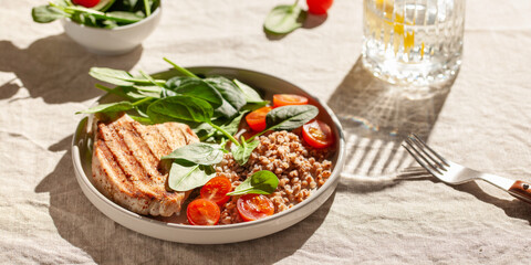Turkey steak or chicken with buckwheat and spinach leaf salad and tomatoes. Water with lemon. Diet food. Hard sunlight.