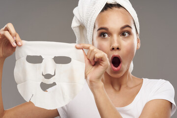 woman with mask against black dots surprised look wide open mouth towels