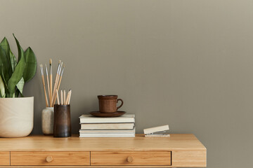 Interior design of neutral bohemian living room interior with stylish desk, book, cup, plant, office supplies, clock, copy space, notes and personal accessories. Template.