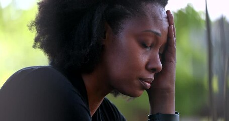Preoccupied black woman feeling stress and pressure. African person suffering - Powered by Adobe
