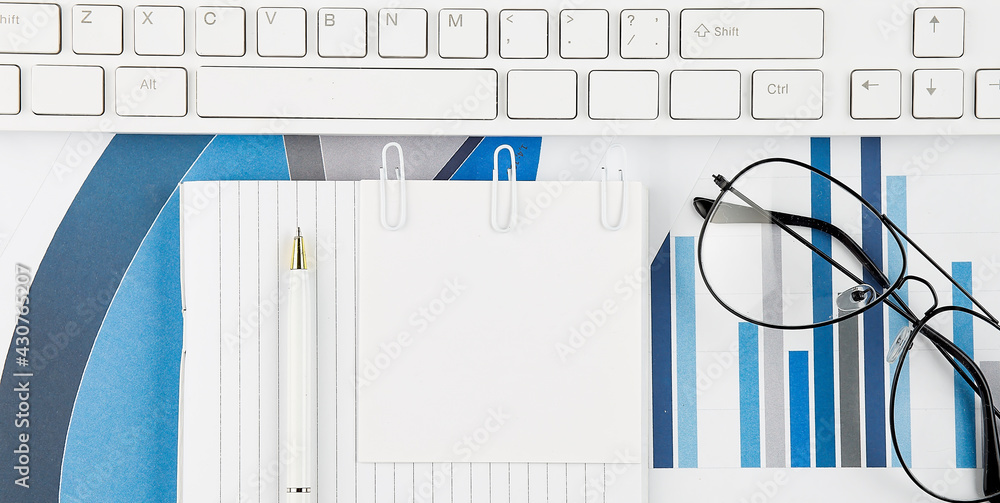 Poster office desk table with keyboard, chart,glasses and pen. top view with copy space