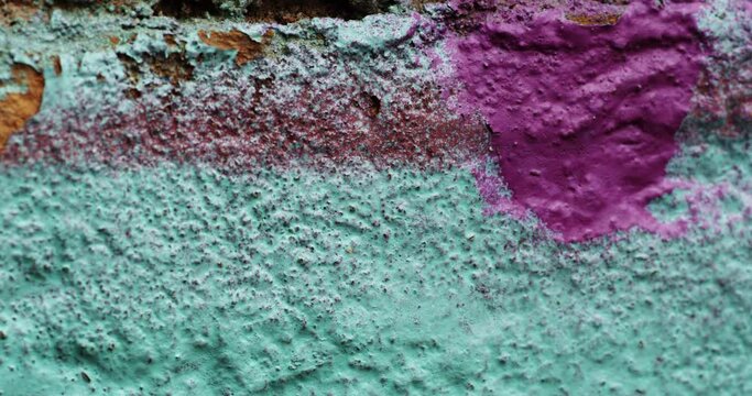 Dolly in shot of an old, painted wall.