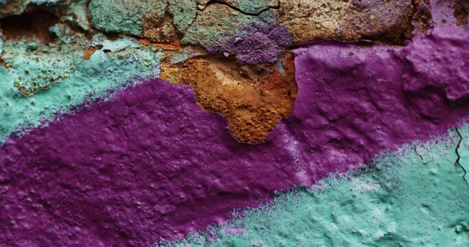 Dolly out close up shot of a chipped, colorful paint.