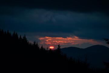 Vibrant Orange Sunset Sun Over the Mountain Pines Forest