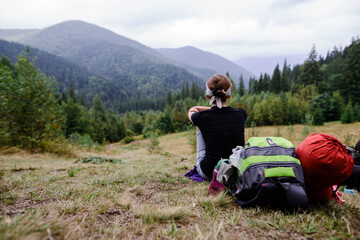 Fototapeta na wymiar Girl Tourist resting on the Mountain Trail Hike Backpacking 