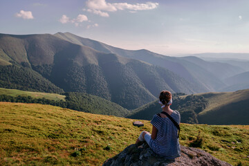 Naklejka na ściany i meble Girl Tourist resting on the Mountain Trail Hike Backpacking 