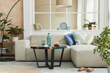 Stylish scandinavian living room interior with neutral modular sofa, design coffee table, window,...