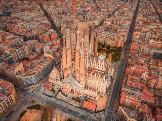 Fototapeten The Cathedral of La Sagrada Familia by the architect Antonio Gaudi, Catalonia, Barcelona Spain - April  2021. Aerial view © pelinoleg