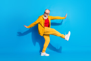 Full size photo of crazy excited positive funky mature man grandfather dancing fooling isolated on blue color background