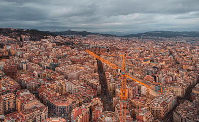 Obraz premium The Cathedral of La Sagrada Familia by the architect Antonio Gaudi, Catalonia, Barcelona Spain - April 2021. Aerial view