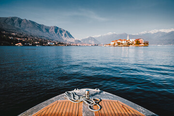 Closeup on a bow of tourist boat while surfing Lake Maggiore with the Borromee Islands in the background