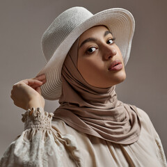 Fashionable young arabian girl in hijab and hat