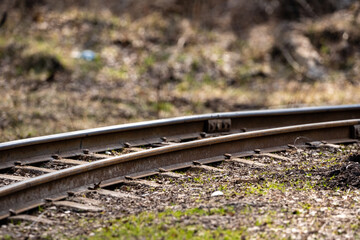 narrow gauge railway in a swamp where there are metal rails and concrete supports