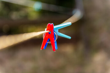 clothespins on a clothesline outdoor in courtyard of rural house
