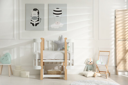 Baby room interior with stylish furniture and toys