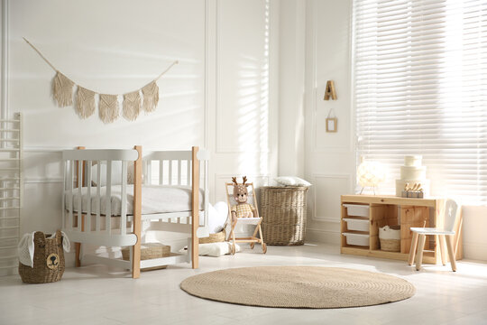 Baby room interior with stylish furniture and toys
