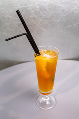 orange cocktail with a slice of orange in a glass glass