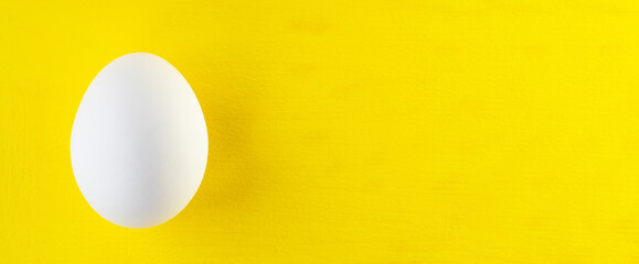 egg isolated on yellow background with space for your text