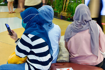 young muslim women sitting, talking and relaxing