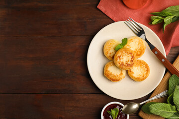 Delicious cottage cheese pancakes with mint on wooden table, flat lay. Space for text