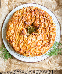 Puff pastry pie with chicken and leek decorated with dill. Top view. © valentinamaslova