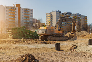 Excavator and screener machine. Heavy equipment on construction site.