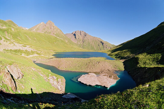 Scenic blue sky summer landscape of Chilik mountain lake with mountain peaks on background on Abishira-Akhuba Ridge in Caucasus mountains by Arkhyz, Russia.