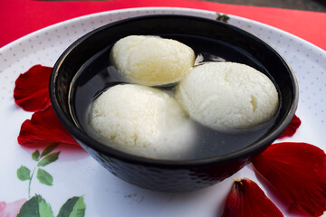Traditional popular Indian sweet dish big size Rasgulla or rosogula , Bengali syrupy dessert sweets.
